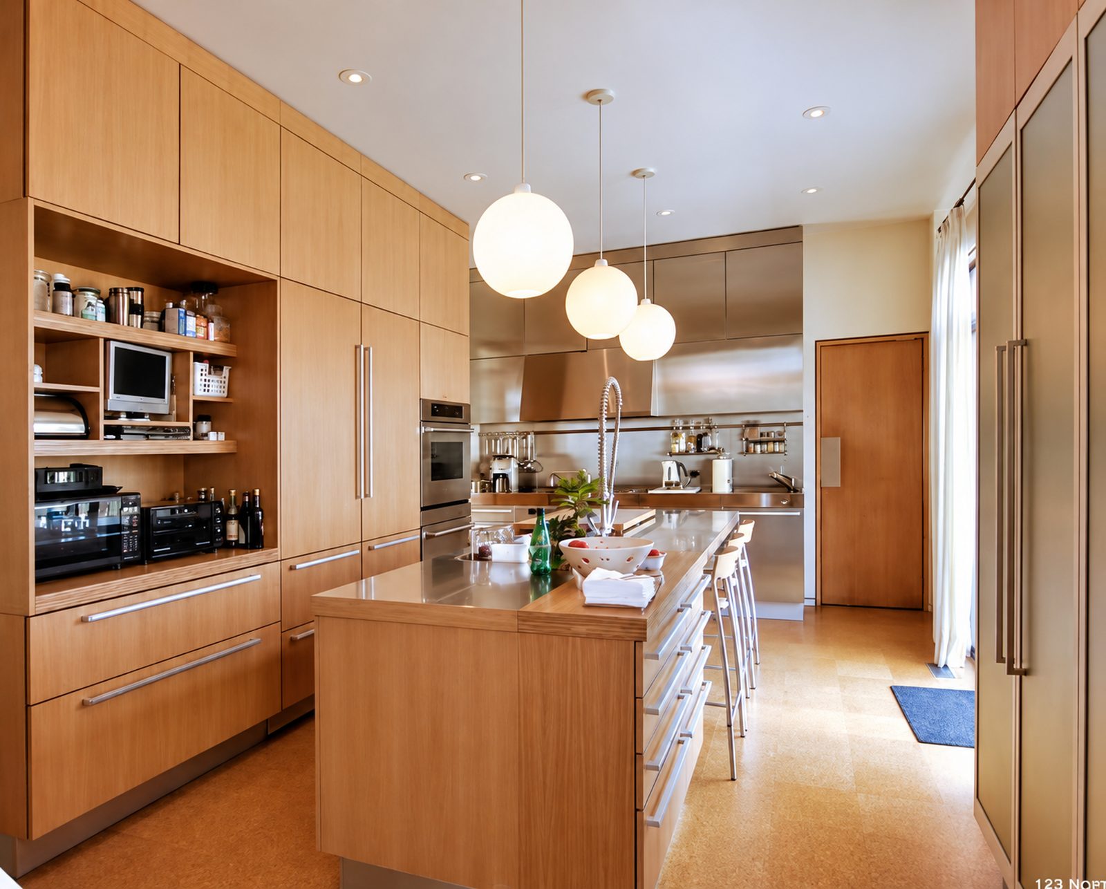 Flat-panel wood kitchen cabinetry with tall storage and an island in Ridgefield, CT.