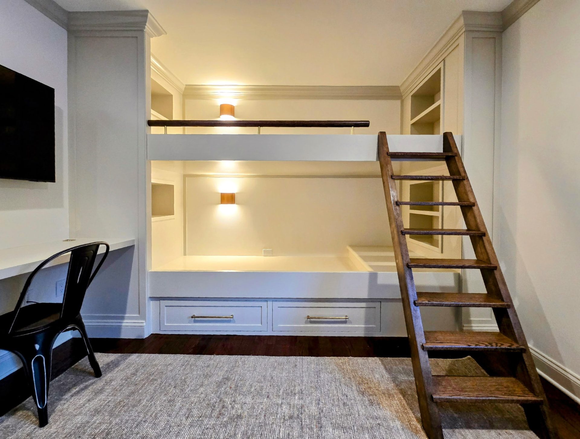 Bunk bed unit showing recessed nooks, built-in shelving and storage drawers before styling