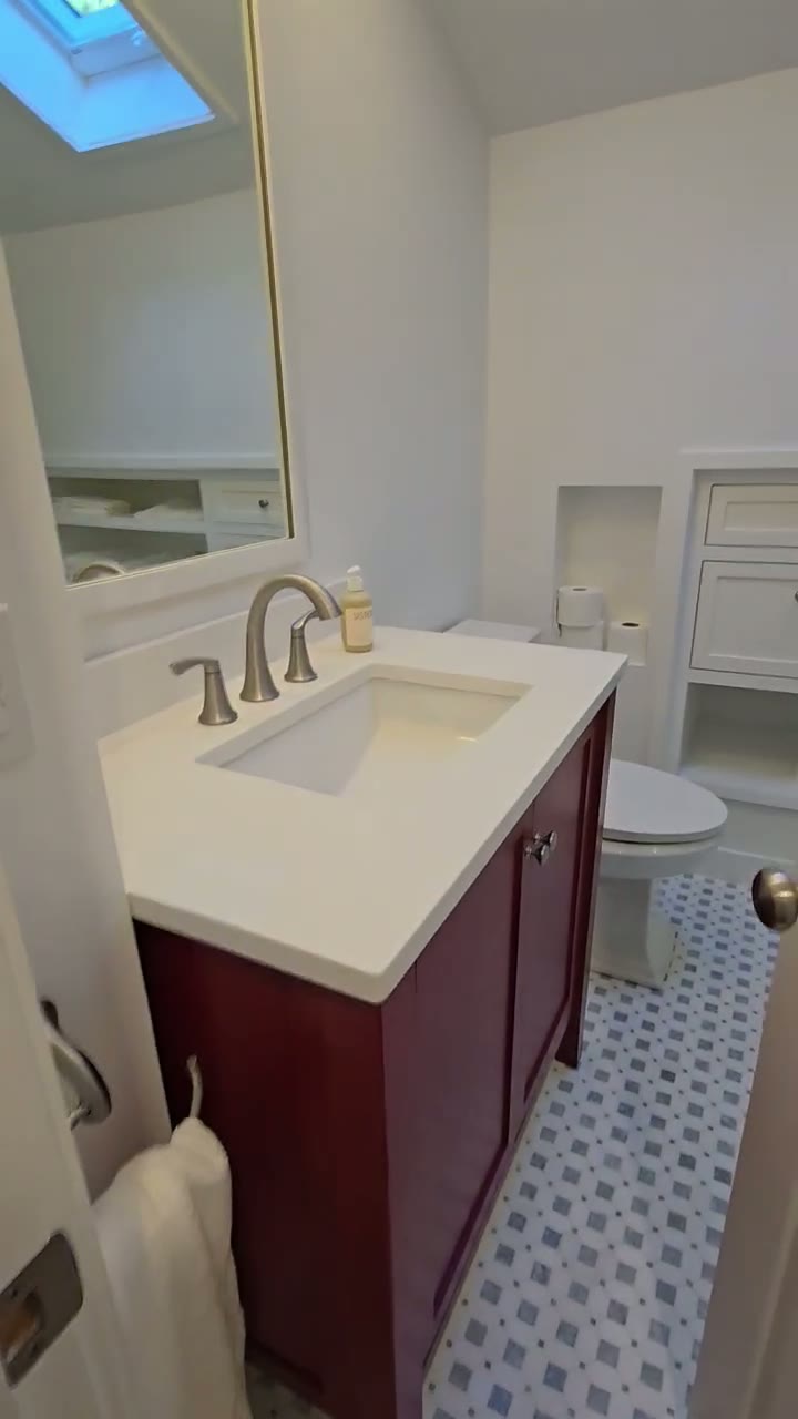 Dark wood custom bathroom vanity with white countertop in Ridgefield, CT