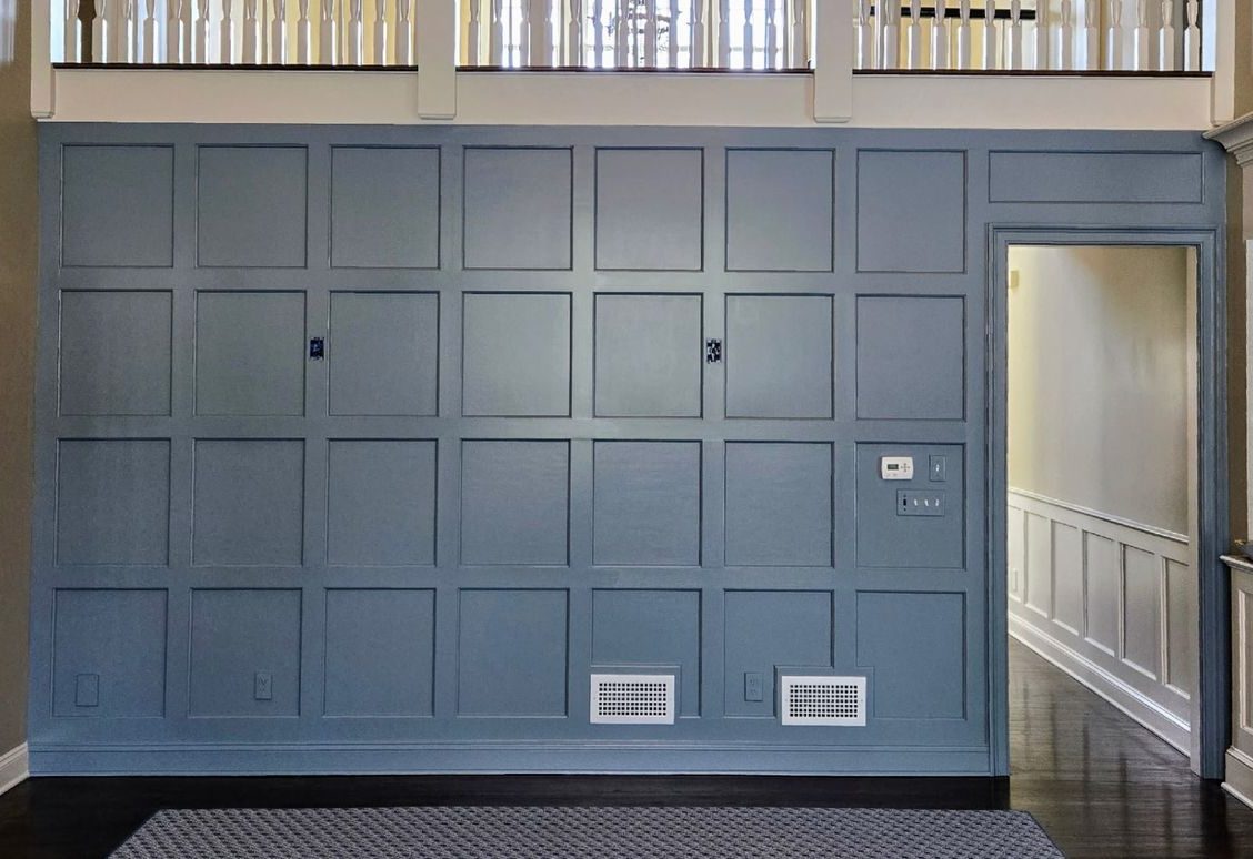 Slate blue custom wall paneling with decorative molding and crown trim in a New Canaan, CT home