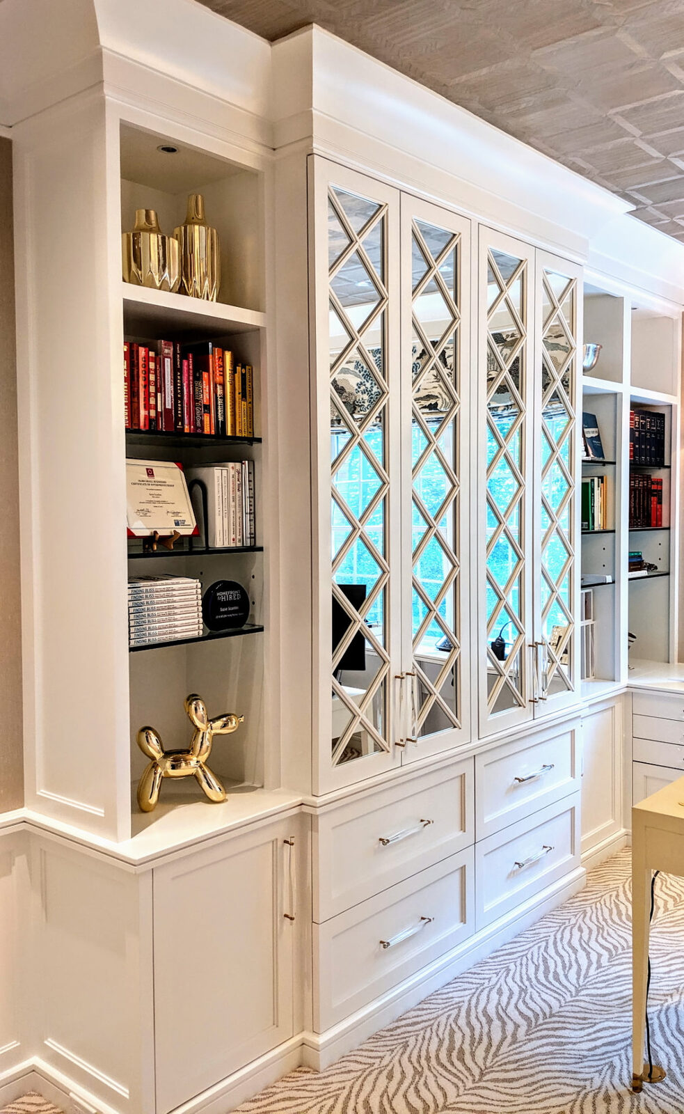Custom home office with glass-front built-in cabinets and bookshelves in Ridgefield CT