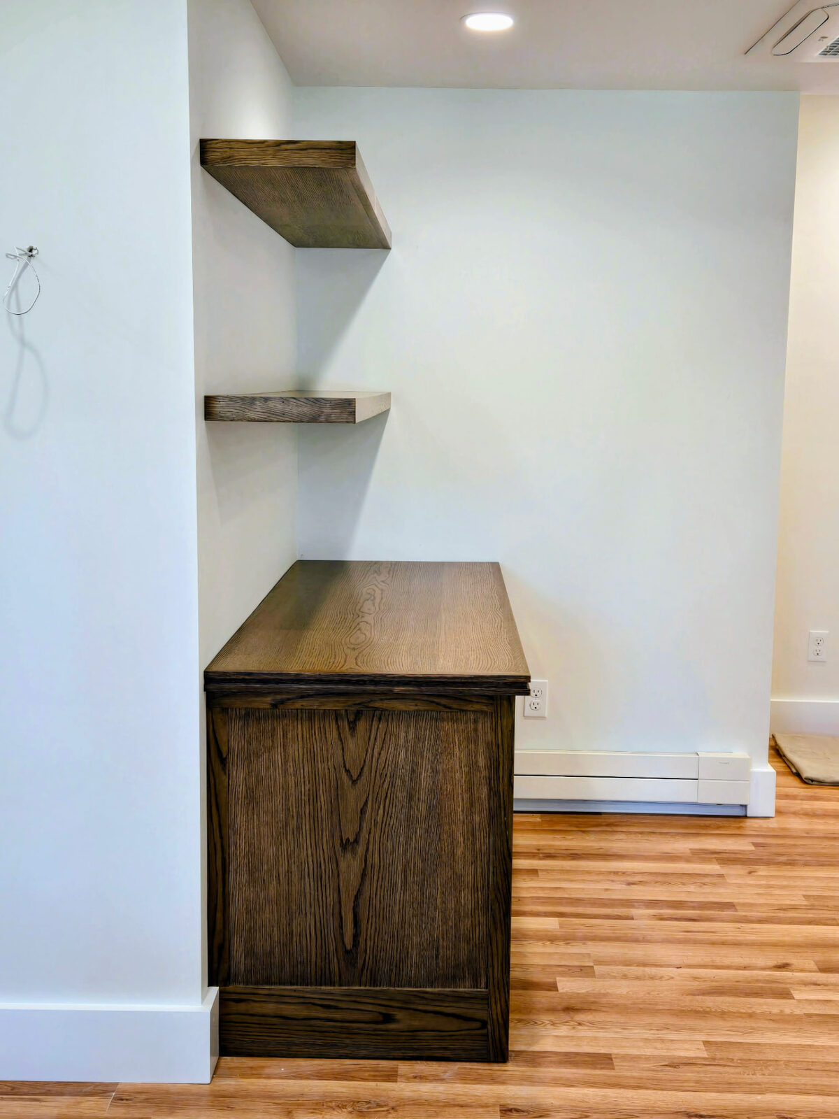 Custom built-in oak desk with matching floating slab shelves in a Ridgefield CT home office