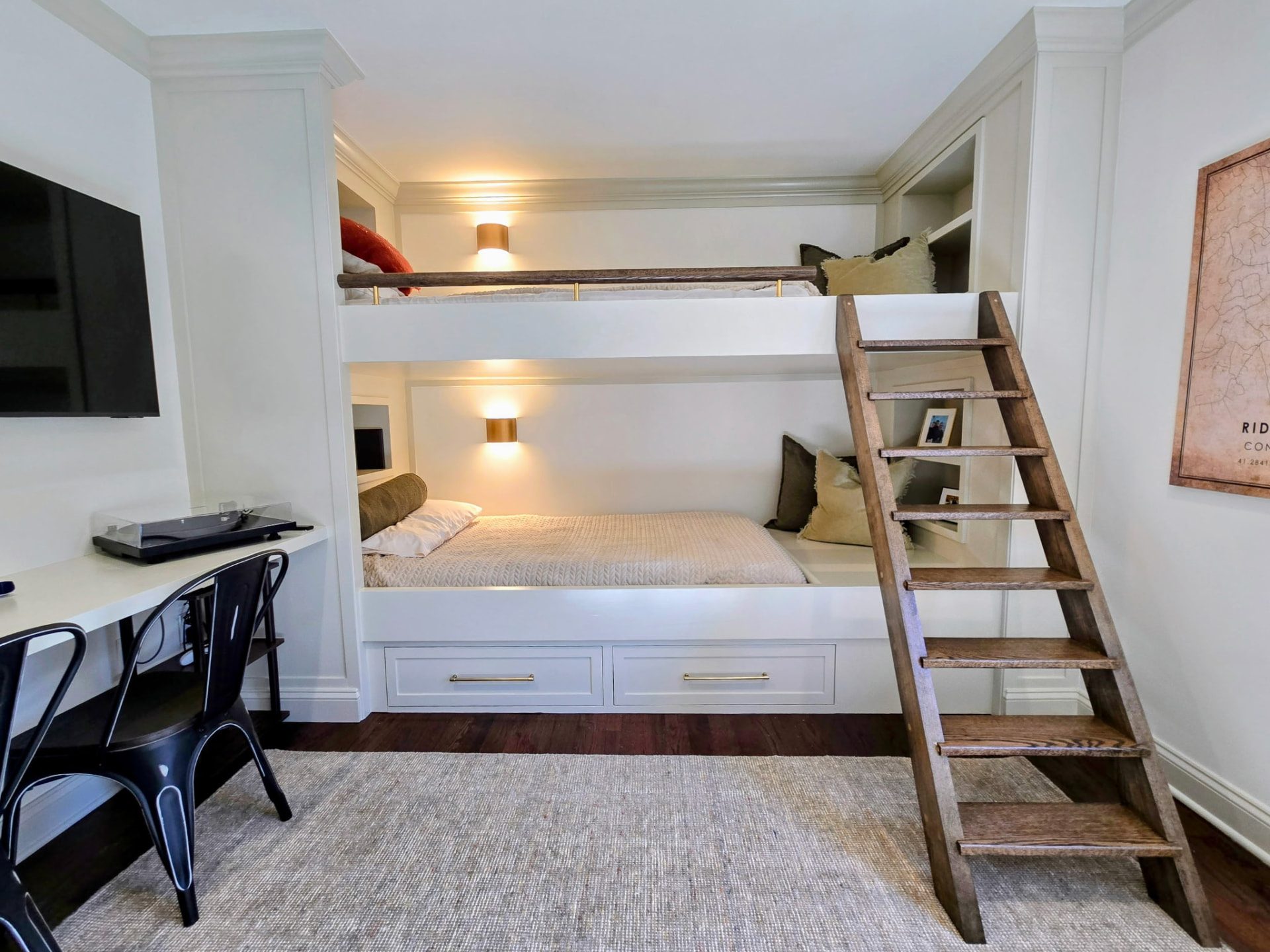Custom built-in white bunk beds with oak ladder in a Ridgefield, CT bedroom